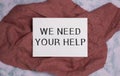 We Need Your Help. Conceptual photo asking someone to stand with you against difficulty Striped note book four