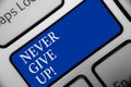 Text sign showing Never Give Up. Conceptual photo Keep trying until you succeed follow your dreams goals Keyboard blue key Intenti Royalty Free Stock Photo