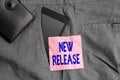 Text sign showing New Release. Conceptual photo announcing something newsworthy recent product Smartphone device inside trousers Royalty Free Stock Photo