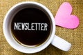 Text sign showing Newsletter. Conceptual photo Bulletin periodically sent to subscribed members News report Tea time coffee cup of