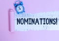 Text sign showing Nominations. Conceptual photo action of nominating or state being nominated for prize Alarm clock and