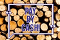 Text sign showing Pay By Cash. Conceptual photo Customer paying with money coins bills Retail shopping Wooden background Royalty Free Stock Photo