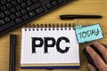 Text sign showing Ppc. Conceptual photo Pay Per Click Advertising Strategies Direct Traffic to Websites written on Notepad on wood Royalty Free Stock Photo