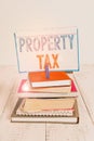 Text sign showing Property Tax. Conceptual photo an ad valorem tax on the value of a property Millage rate pile stacked