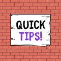 Text sign showing Quick Tips. Conceptual photo small but particularly useful piece of practical advice Wooden square