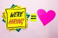 Text sign showing We're Hiring. Conceptual photo Recruiting Hiring Now Recruitment Vacancy Announced Hire written on Yellow Stick