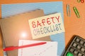 Text sign showing Safety Checklist. Conceptual photo list of items you need to verify, check or inspect Striped paperboard