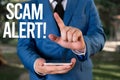 Text sign showing Scam Alert. Conceptual photo fraudulently obtain money from victim by persuading him Man with opened Royalty Free Stock Photo