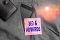 Text sign showing Seo And Adwords. Conceptual photo they are main tools components of Search Engine Marketing Smartphone device