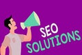 Text sign showing Seo Solutions. Conceptual photo Search Engine Result Page Increase Visitors by Rankings Man in Shirt Standing