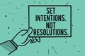Text sign showing Set Intentions. Not Resolutions.. Conceptual photo Positive choices for new start achieve goals Man hand holding