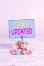 Text sign showing Stay Updated. Conceptual photo keep modern recent or containing the latest information Reminder pile