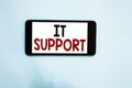 Text sign showing It Support. Conceptual photo Lending help about information technologies and relative issues Cell phone white sc Royalty Free Stock Photo