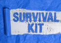 Text sign showing Survival Kit. Conceptual photo Emergency Equipment Collection of items to help someone Rolled ripped