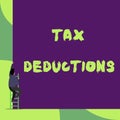 Text sign showing Tax Deductions. Conceptual photo an amount or cost that subtracted from someone s is income Back view Royalty Free Stock Photo
