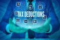 Text sign showing Tax Deductions. Conceptual photo an amount or cost that subtracted from someone s is income Male human Royalty Free Stock Photo