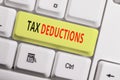 Text sign showing Tax Deductions. Conceptual photo an amount or cost that subtracted from someone s is income White pc Royalty Free Stock Photo