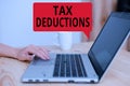 Text sign showing Tax Deductions. Conceptual photo an amount or cost that subtracted from someone s is income woman Royalty Free Stock Photo