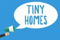 Text sign showing Tiny Homes. Conceptual photo houses contain one room only or two and small entrance Cheap Man holding megaphone