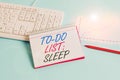 Text sign showing To Do List Sleep. Conceptual photo Things to be done Priority object is to take a rest Paper blue desk
