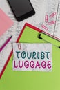 Text sign showing Tourist Luggage. Conceptual photo big bag that contains everything one needs for traveling Clipboard sheet Royalty Free Stock Photo