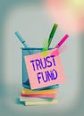 Text sign showing Trust Fund. Conceptual photo money that is being held by the trustees for the beneficiaries Sticky note arrow