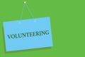 Text sign showing Volunteering. Conceptual photo Provide services for no financial gain Willingly Oblige Blue board wall message c