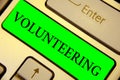 Text sign showing Volunteering. Conceptual photo Provide services for no financial gain Willingly Oblige Keyboard green key Intent