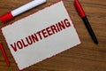 Text sign showing Volunteering. Conceptual photo Provide services for no financial gain Willingly Oblige White paper red