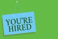 Text sign showing You re are Hired. Conceptual photo New Job Employed Newbie Enlisted Accepted Recruited Blue board wall message c Royalty Free Stock Photo