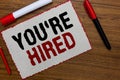 Text sign showing You re are Hired. Conceptual photo New Job Employed Newbie Enlisted Accepted Recruited White paper red borders m Royalty Free Stock Photo