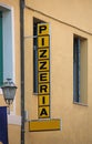 text of the sign with the text pizzeria which in Italian is the place where pizzas are served