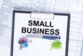 Text Small Business on folder with clip. Pen with paper clips on financial table Royalty Free Stock Photo