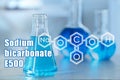 Text Sodium bicarbonate E500 with soda formula and laboratory glassware Royalty Free Stock Photo