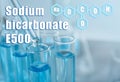 Text Sodium bicarbonate E500 with formula and test tubes on background Royalty Free Stock Photo