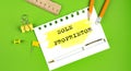 Text SOLE PROPRIETOR sign showing on green background with office tools