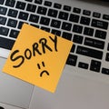 Text Sorry on sticky note.  Orange note on keyboard Royalty Free Stock Photo