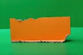 text space copy background modern bright background green edges torn cardboard corrugated orange piece a Royalty Free Stock Photo