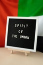 Text SPIRIT OF THE UNION on background flag of UAE. National holiday of United Arab Emirates. Commemoration Day Muslim Royalty Free Stock Photo