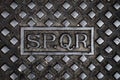 Text SPQR in a cast iron manhole cover in Rome