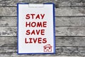 Text Stay home save lives on white paper Royalty Free Stock Photo