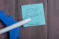 Text Stop flights Coronavirus on sticky note and airplane model on wooden background