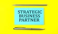 Text STRATEGIC BUSINESS PARTNER on the blue sticker on the yellow background