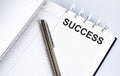 Text SUCCESS on the short note texture background with pen Royalty Free Stock Photo