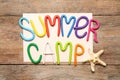 Text SUMMER CAMP made of modelling clay and starfish on wooden table Royalty Free Stock Photo