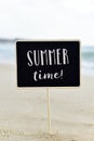 Text summer time in a signboard on the beach Royalty Free Stock Photo