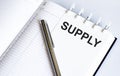 Text SUPPLY on the short note texture background with pen Royalty Free Stock Photo