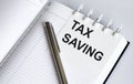 Text Tax Saving on the short note texture background with pen Royalty Free Stock Photo