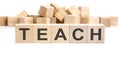 text TEACH made of wooden cubes and different words on white background