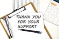 Text THANK YOU FOR YOUR SUPPORT on the white paper on clipboard with chart and calculator Royalty Free Stock Photo